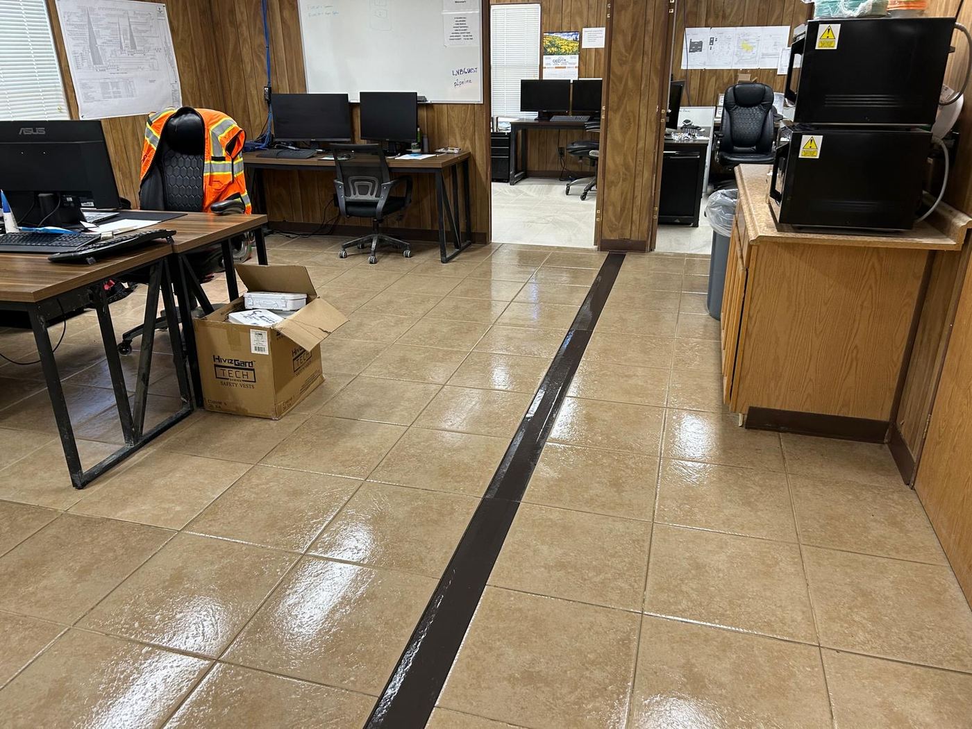 An office floor mopped to a clean shine between desks