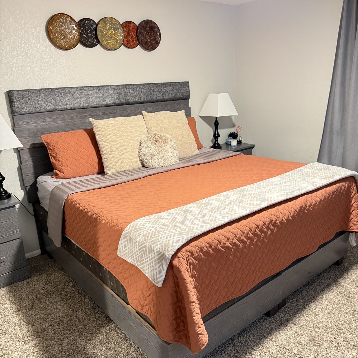 A bedroom with the bed made and the room tidied