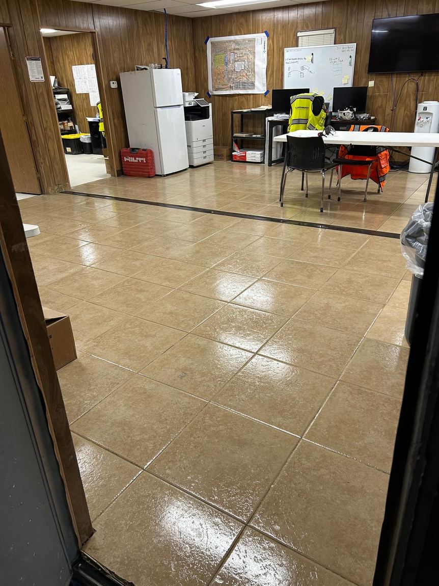A large tiled office floor mopped to an even shine
